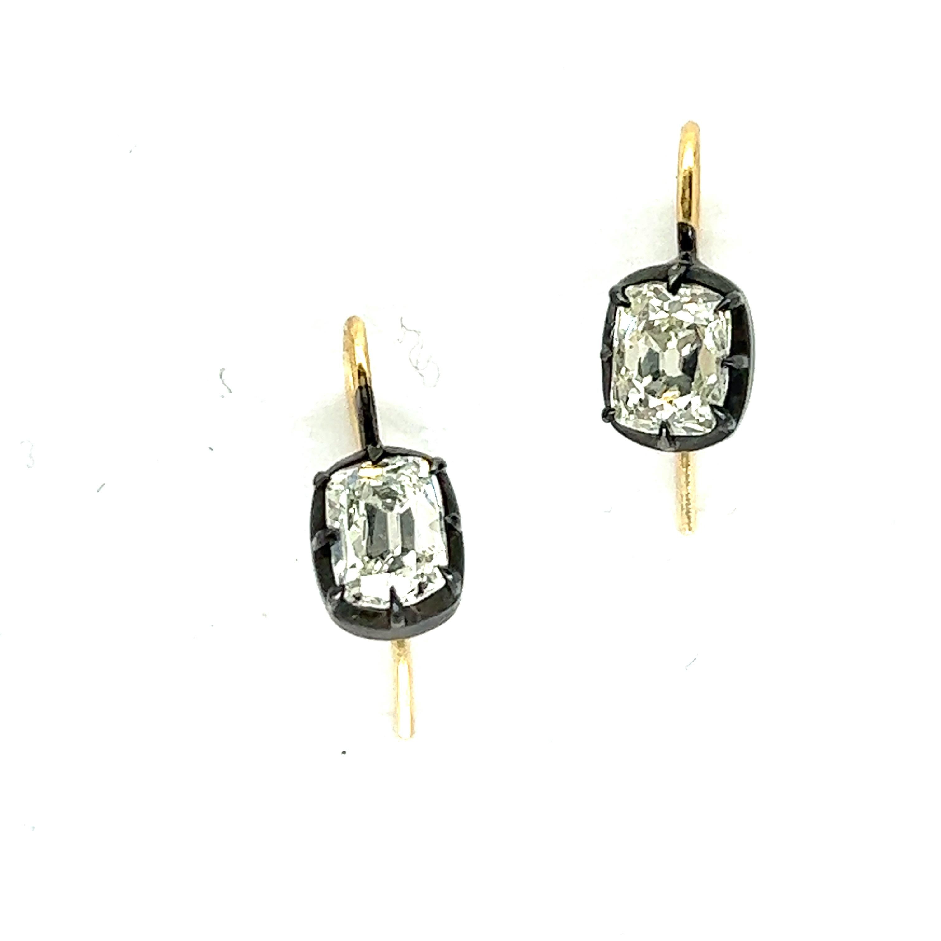 Pair of delicate 18k gold and silver earrings, featuring hook wires. Set with two cushion cut diamonds - approx. 2.15ctw total. Si1/H. Earrings measure 14mm x 6mm. Weight of the pair - 1.9 grams. 
