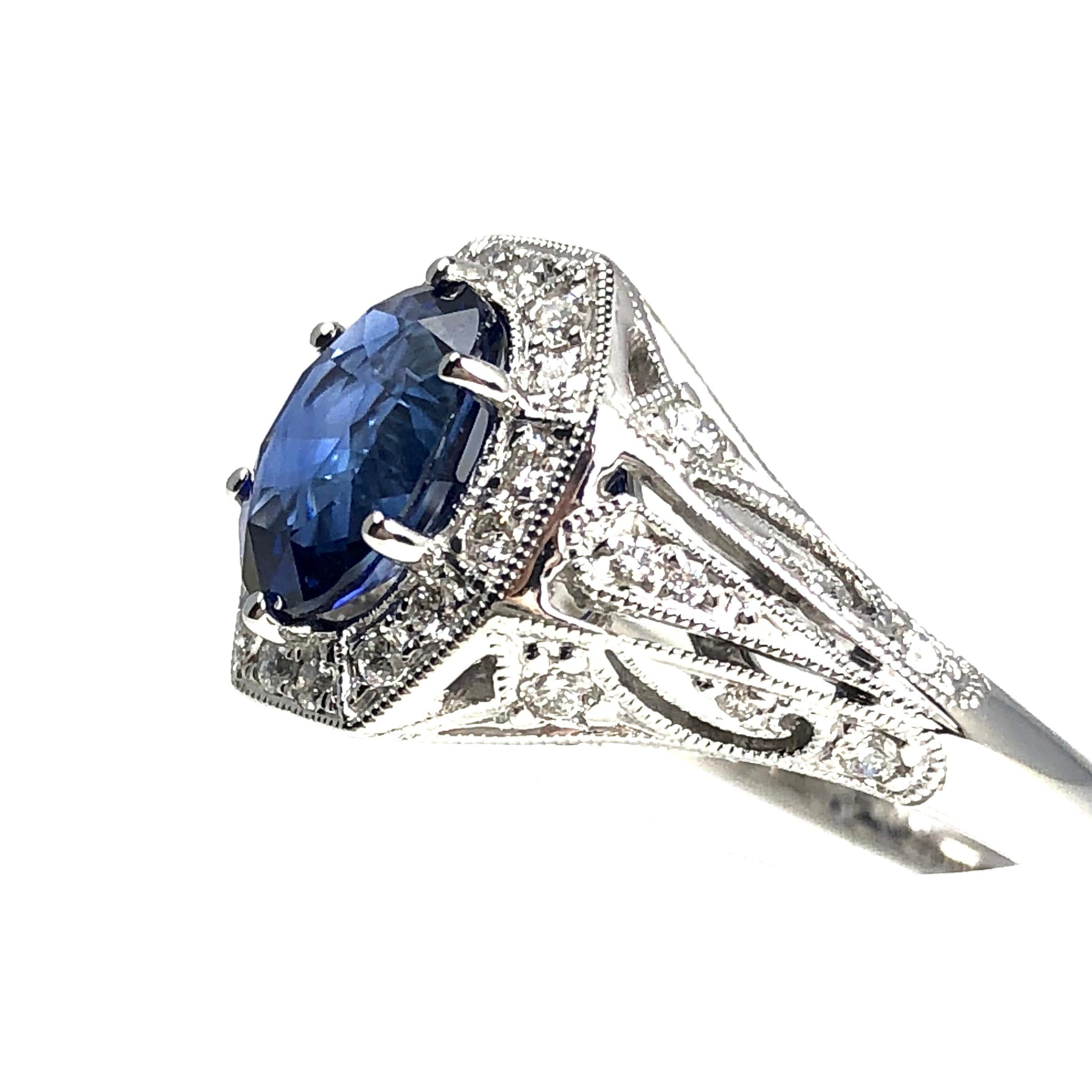 (DiamondTown) This ring has a 2.02 carat oval cut fine blue sapphire center, surrounded by 0.43 carats round diamonds.

Center: 2.02 carats oval cut blue sapphire
46 round diamonds are 0.43 carats
Set in 18k White Gold.

This ring is size 6.5, but