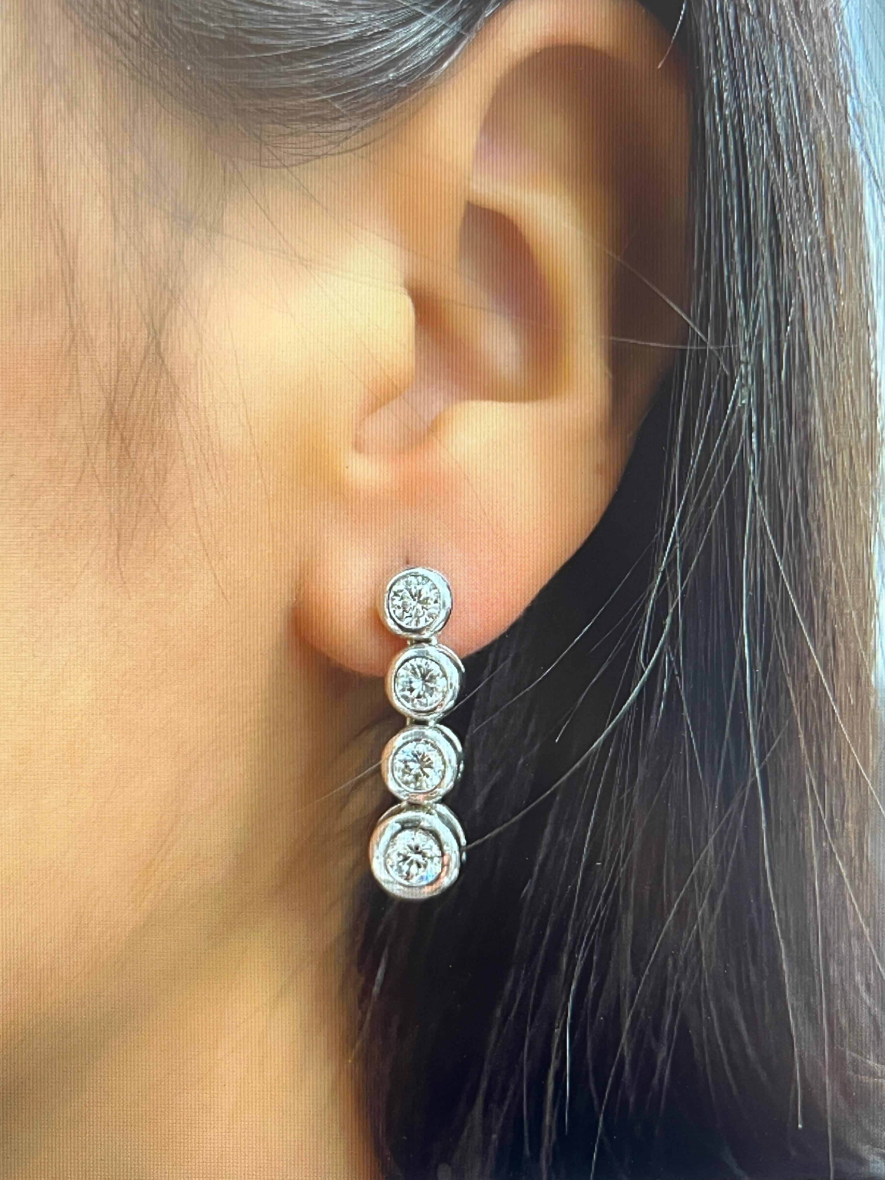 These gorgeous 2.02 ct diamond dangle earrings feature 8 round diamonds set in 14k white gold. The diamonds are G/H in color and VS2/SI1 in clarity. An amazing addition to any wardrobe!