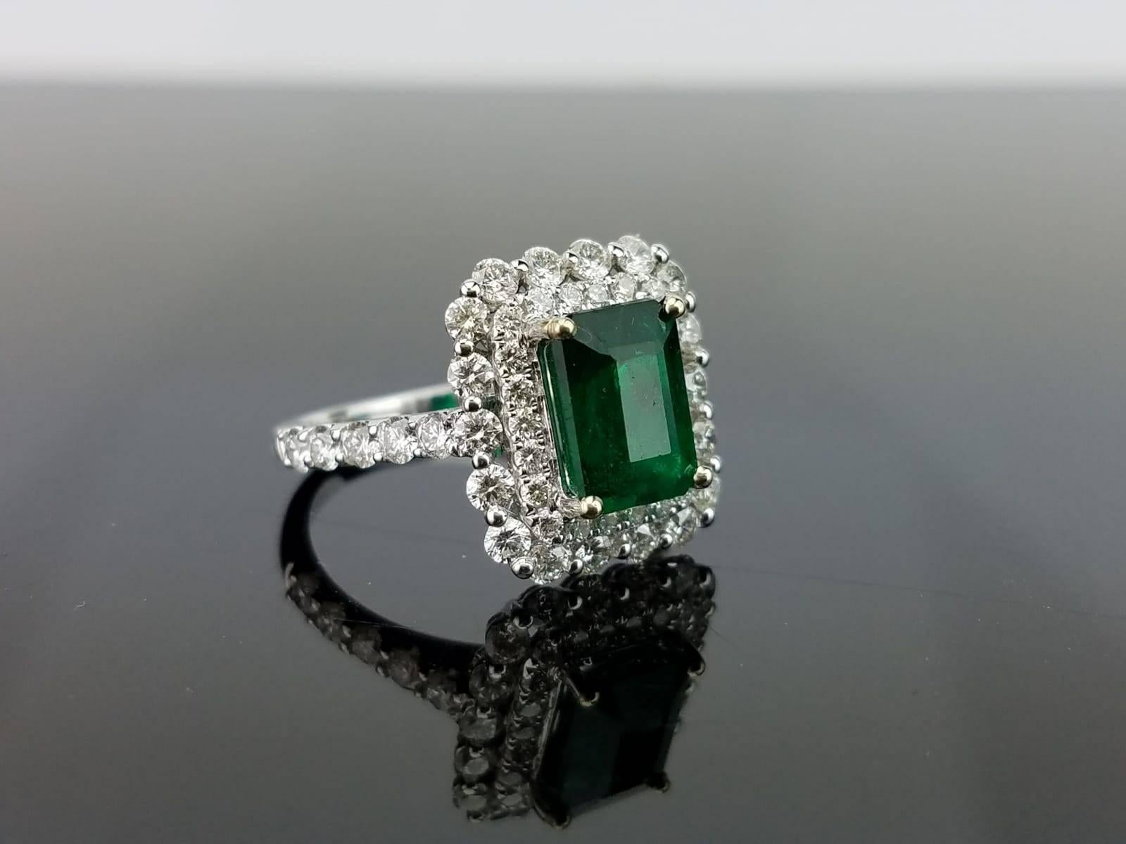 A stunning, transparent Zambian Emerald with a great deep green colour and lustre and no apparent inclusions, adorned with White Diamonds, all set in 18K white gold. 

Stone Details: 
Stone:  Zambian Emerald
Carat Weight: 2.02 carats

Diamond
