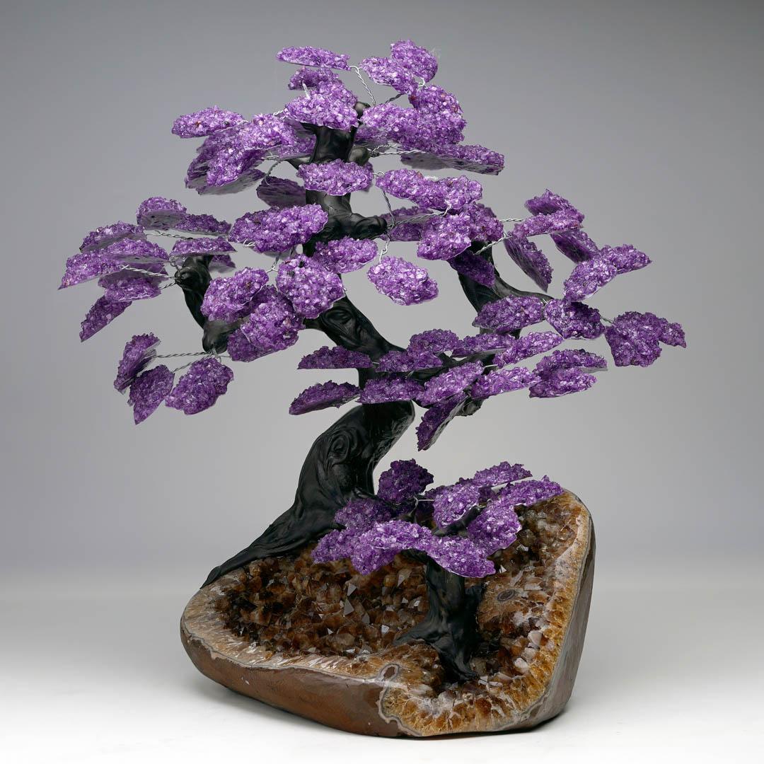 Add a touch of natural elegance to your space with this stunning handcrafted Amethyst and Citrine Gem Tree. Featuring vibrant purple Amethyst crystal clusters, this decorative piece is rooted in a genuine sparkling Citrine Geode base that showcases