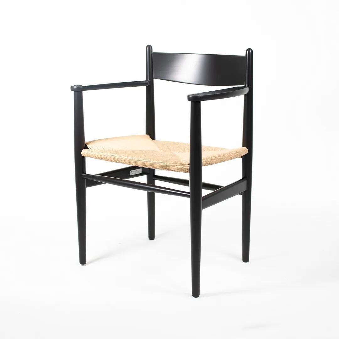 This is a single (two are available, though the price listed is for each chair) CH37 Dining Chair designed by Hans Wegner and produced by Carl Hansen & Son in Denmark. The chair is made with a solid beech frame, painted black with a natural paper