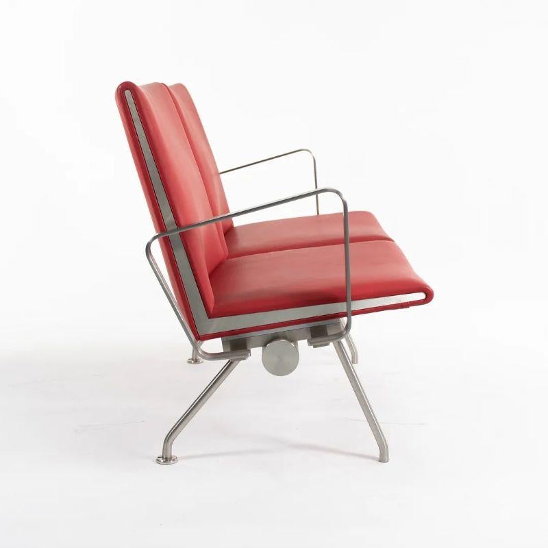 Listed for sale is a two-seater Kastrup sofa model CH402 with arms, designed by Hans Wegner , produced by Carl Hansen & Son in Denmark. The sofa is made with a stainless steel frame and red leather. It was produced circa 2020 and is guaranteed as