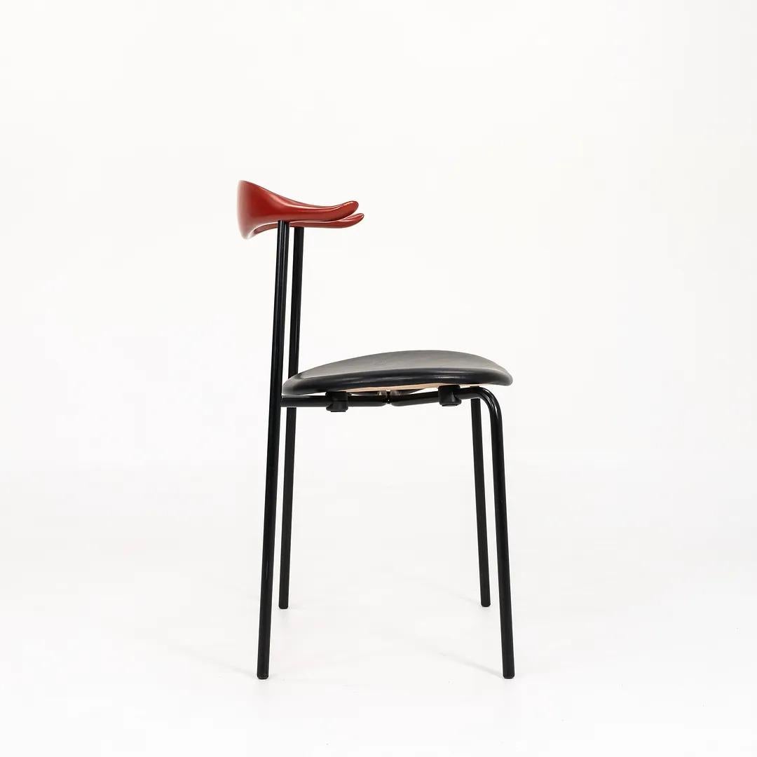 Listed for sale is a CH88P Dining Chair, made with a black powder coated steel frame, beech backing painted a red/brown color, and SIF 98 black leather seat. The chair, designed by Hans Wegner and produced by Carl Hansen & Son in Denmark, dates