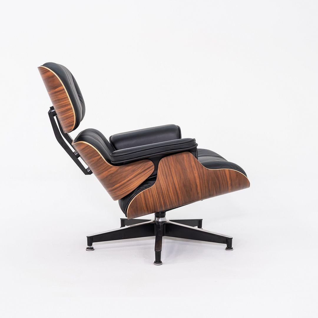 This is an Eames Lounge Chair and Ottoman, models 670 and 671, designed by Charles and Ray Eames for Herman Miller in 1956. This particular example was produced in 2020. These pieces are comprised of walnut-veneered plywood shells and cushions