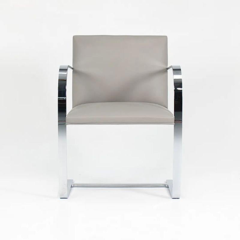 This is the 2020 production Flat Bar Brno Chair, designed by Mies Van Der Rohe and manufactured by Knoll. The price listed is for each chair. Four chairs are available in gray leather as shown (twelves were available, but eight have sold). There was