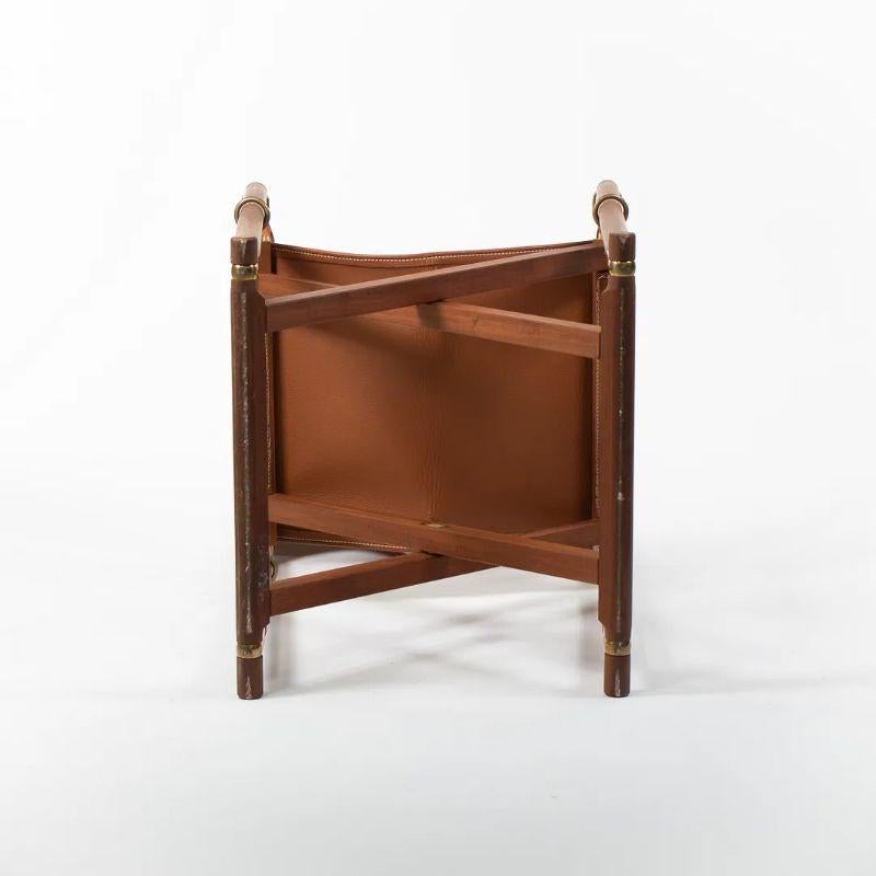This is a listing for two (sold separately) MK99200 Folding Chairs made with a solid and oiled teak frame, leather seat/back and leather armrests. The chairs, designed by Mogens Koch and produced by Carl Hansen & Son in Denmark, date to circa 2020.