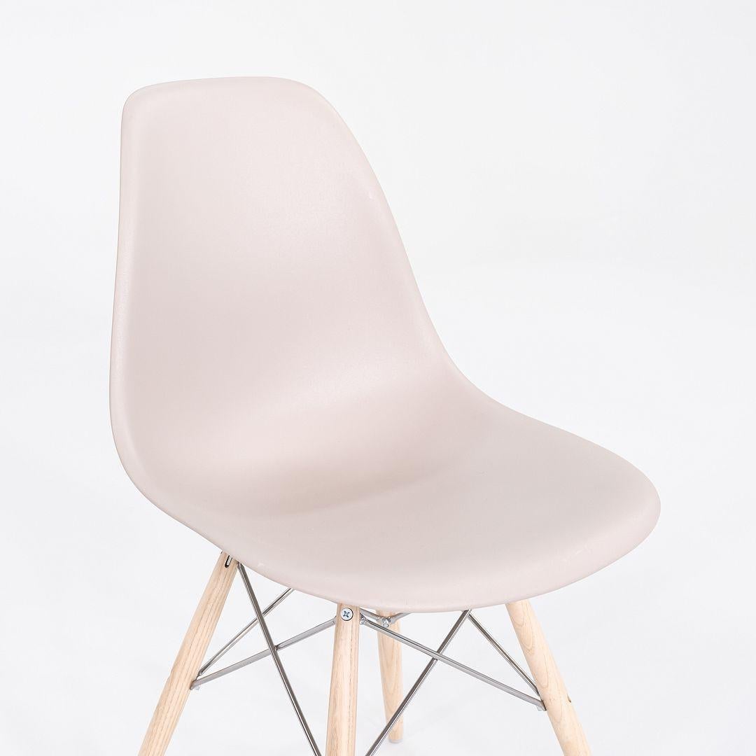 This is a pair of Eames DSW Side Chairs, originally designed by Ray and Charles Eames for Herman Miller in 1948. These examples were produced by Herman Miller in the USA in 2020. Their design features a molded plastic shell seat in tan, and these