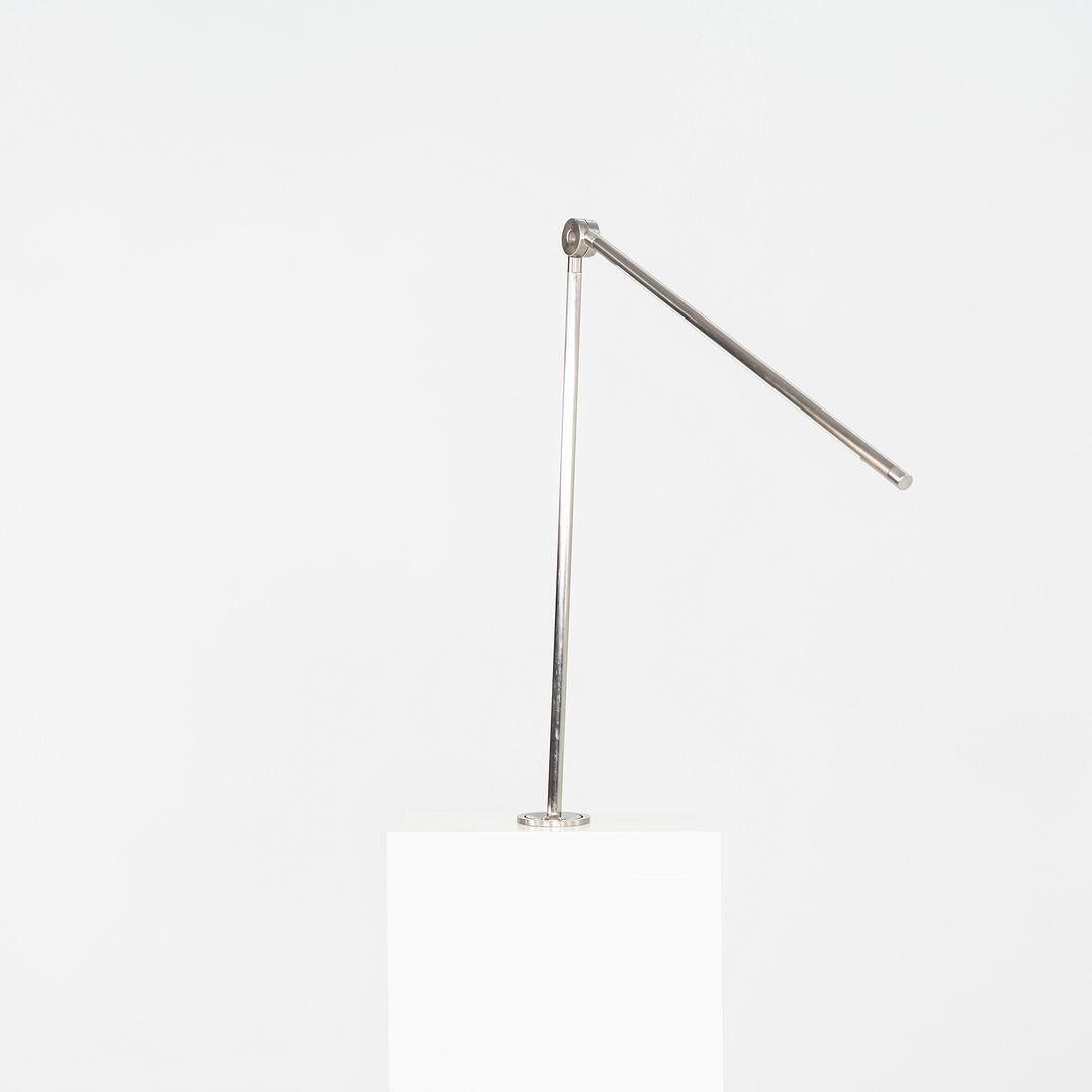 This is a Thin Task Lamp, originally designed by Peter Bristol for Juniper Design in 2016. Finished in satin nickel, each lamp features an ultra-slim LED arm with a precision-machined base designed for seamless desk inset installation. With
