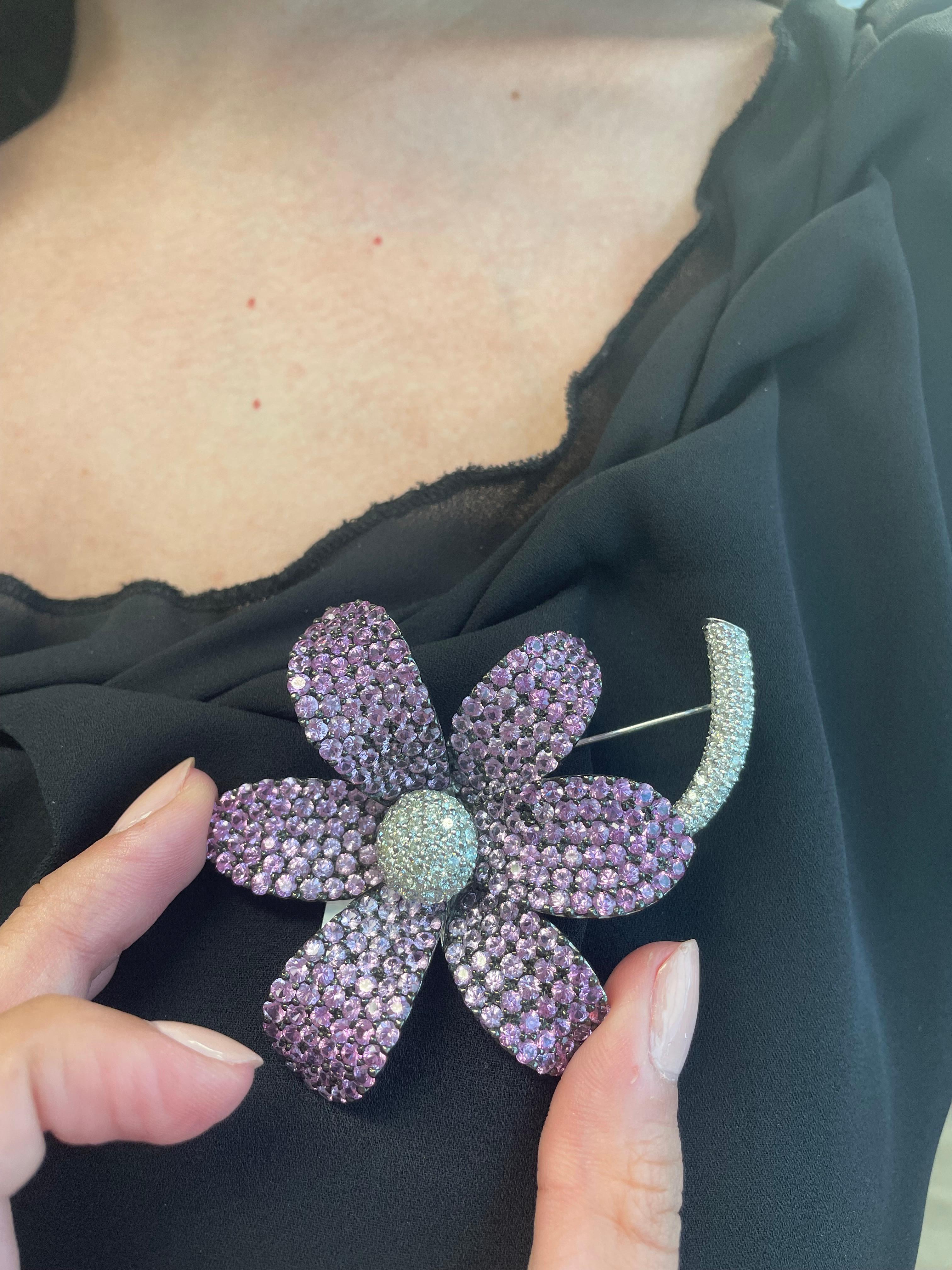 Stunning pink sapphire with diamonds flower brooch. 
20.20 carats of round cut pink sapphires heat. Complimented by 3.01 carats of round brilliant diamonds. Approximately G/H color grade and SI clarity grade. 18-karat white gold, 3in length. 
23.21
