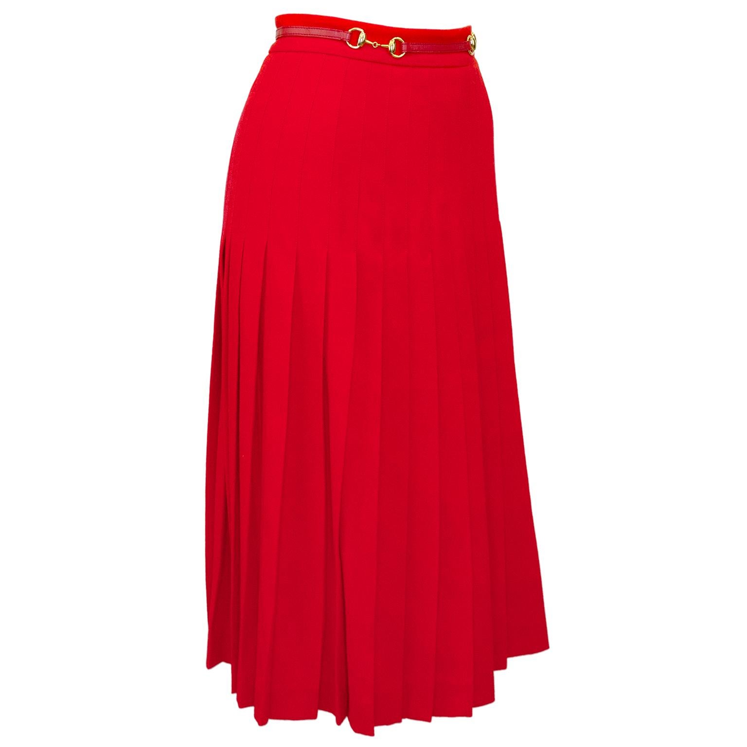 Gucci by Alessandro Michele 1970s inspired red wool skirt. High waisted with inverted pleats and a thin attached red leather belt. Belt is embellished with gold metal horse bits, a motif that dates back to the inception of the Gucci brand. Zipper