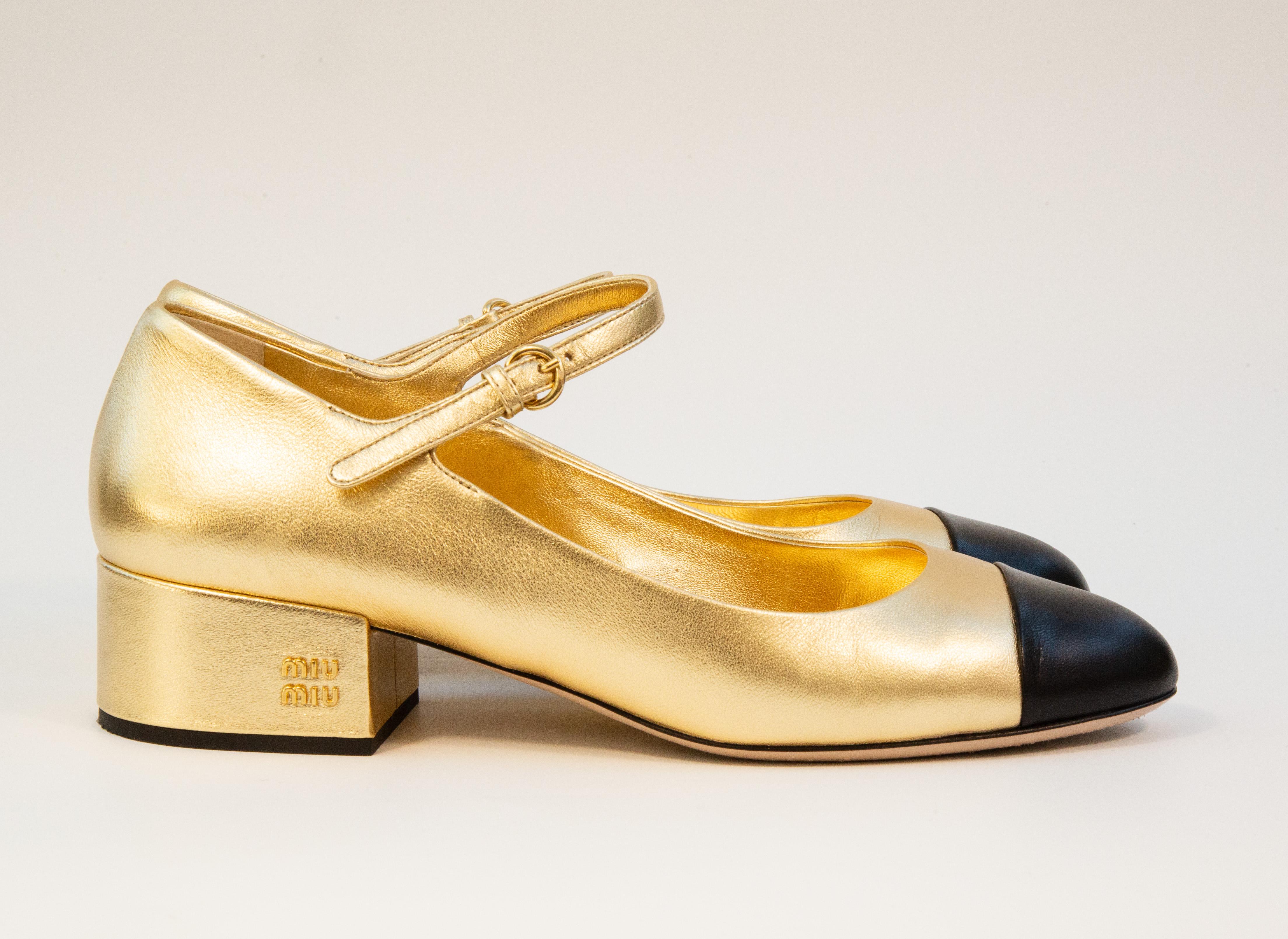 Miu Miu logo leather Mary Jane pumps made of gold and black leather with a buckle fastening ankle strap. The pumps are in very good condition with signs of use on the leather soles and a couple of superficial marks on the leather, please see the