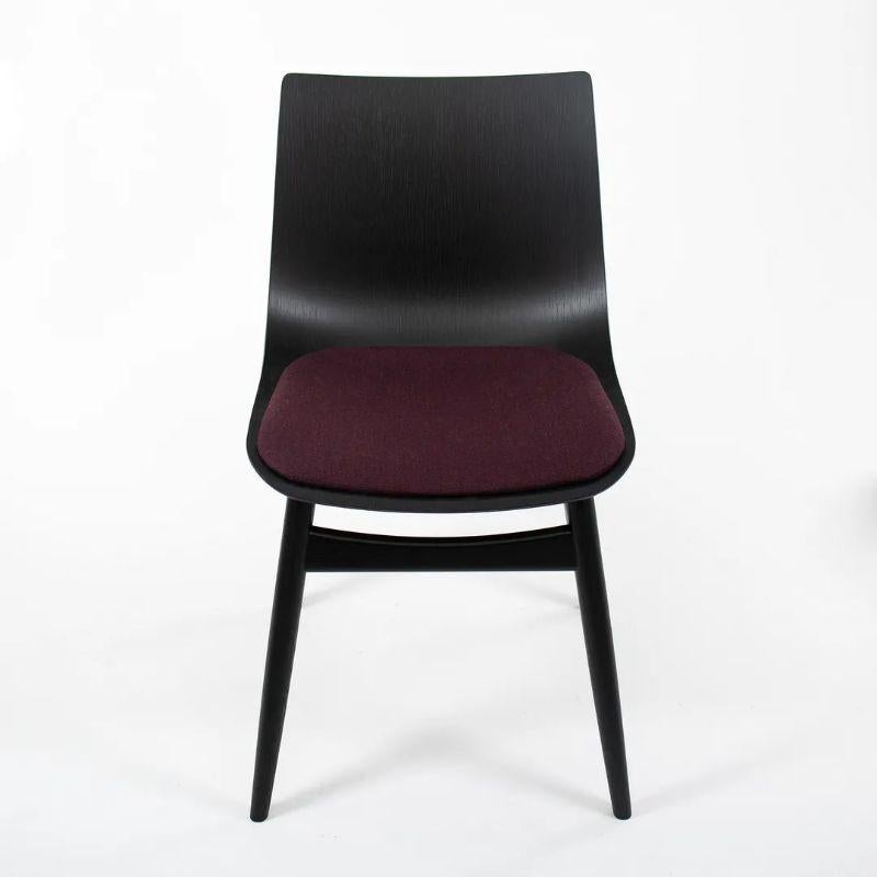 Listed for sale is a BA001S Preludia Wood Chair, designed by Brad Ascalon and produced by Carl Hansen & Son in Denmark. The chair is made with an ebonized oak/beech frame and purple fabric seat. The chair dates circa 2021 and is guaranteed as