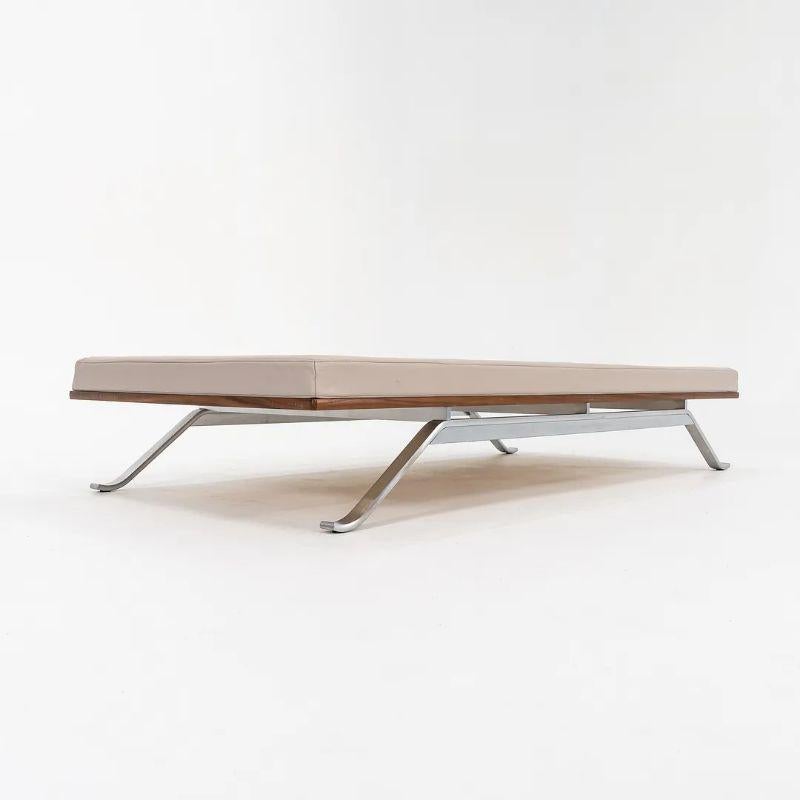 This is a TK8 Daybed made with a stainless steel frame and tan leather cushion on a walnut base. The daybed, designed by Thomas Bo Kastholm, and produced by Carl Hansen & Son in Denmark, dates to circa 2021 and is guaranteed as authentic. Condition