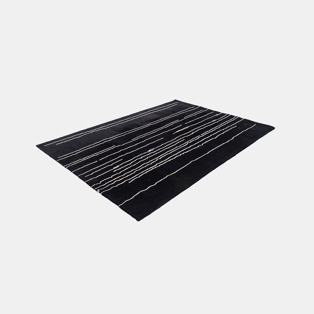 Listed for sale is a NUP003 Woodlines area rug made with hand knotted woolen yarn in ivory white with ivory white lines. The rug was designed by Naja Utzom Popov and produced by Carl Hansen in Denmark. It dates to circa 2022 and is guaranteed as