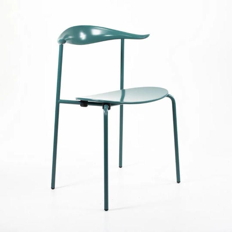 This is a CH88T dining chair made with a turquoise powder coated steel frame, beech back and wood seat. The chair was designed by Hans Wegner and produced by Carl Hansen & Son in Denmark. The chair dates to 2021 and is guaranteed as authentic.