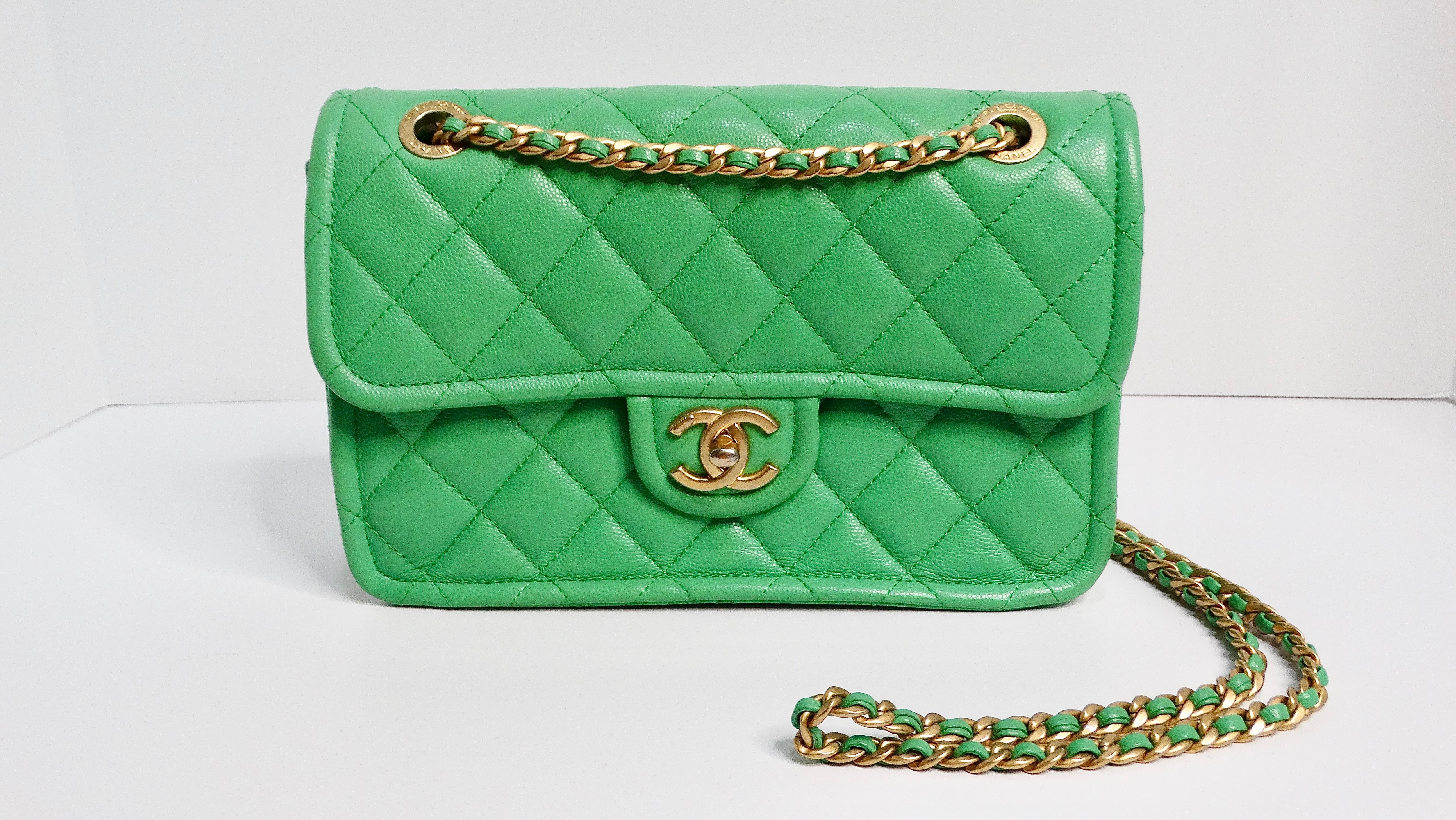 The 2021 Chanel Mint Green Caviar Leather Flap Bag with Gold Hardware is a striking accessory that effortlessly combines classic elegance with a vibrant, modern touch. Crafted from luxurious caviar leather, this bag features the iconic Chanel