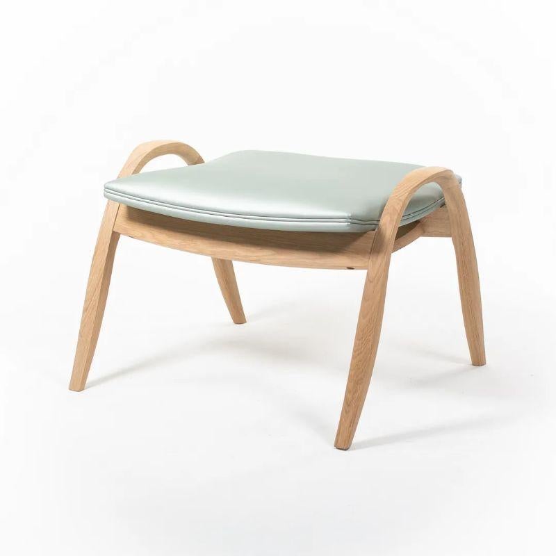 Listed for sale is an FH430 Signature Footstool with an oiled solid oak frame and a light (minty) green leather cushion. The footstool, designed by Frits Henningsen and produced by Carl Hansen & Son in Denmark, was produced circa 2021 and is