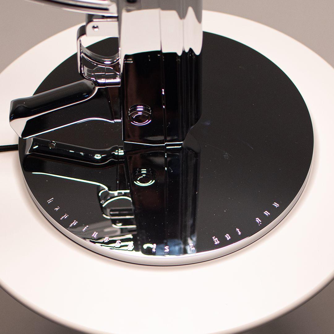 Listed for sale is a Gun Table Lamp made with an chromed die-cast aluminum base and a black plasticized paper shade silkscreened on the inside. The lamp was designed by Philippe Starck, produced by Flos¬†in Italy and dates to circa 2021. It is
