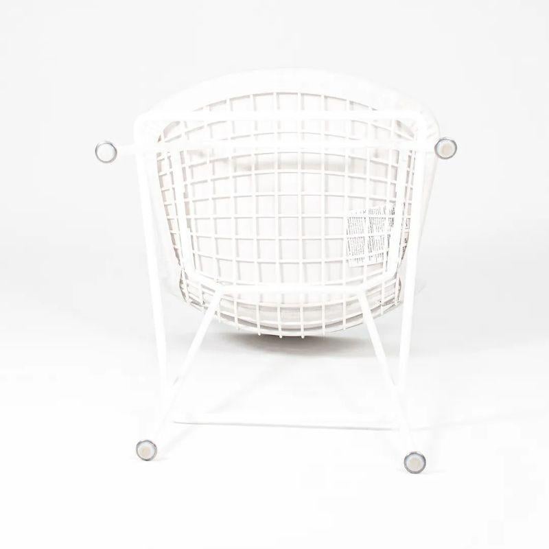 This is a classic 2021 production Harry Bertoia for Knoll Counter Stool, Model 426C, originally designed in 1952. The piece is fabricated of a welded steel basket seat that is coated in white Rilsan and retains its original fully-upholstered seat