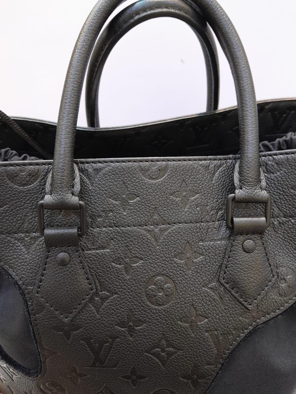 Japan exclusive Louis Vuitton x Rei Kawakubo cut out Monogram empreinte tote bag. Comes with the lining and dust bag. Super rare. In very good condition overall, only signs of storage.