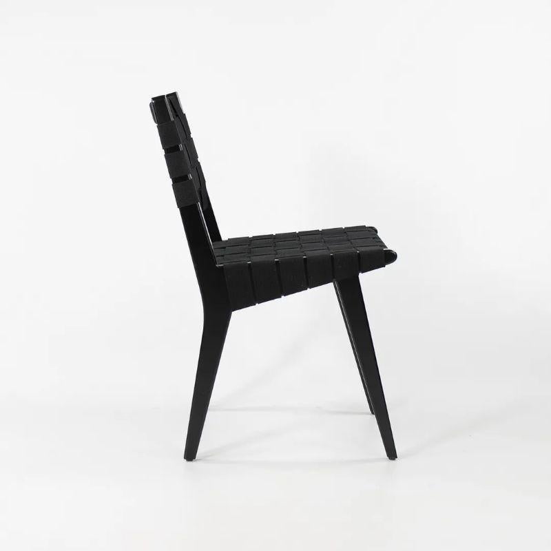 Listed for sale is a single Risom dining chair in ebonized maple with black cotton webbing designed by Jens Risom and produced by Knoll. This example was produced in 2021 and came directly from a Knoll employee, who acquired it at an employee sale.