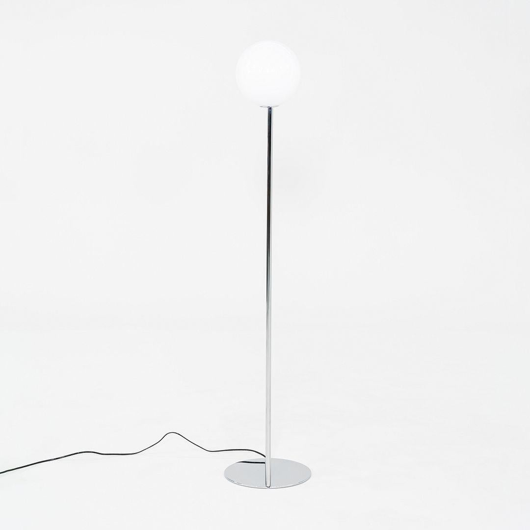 This is an IC F1 Floor Lamp, originally designed by Michael Anastassiades for Flos in 2014. This particular example dates to 2021 and was produced in Italy. The lamp is comprised of steel and blown glass. 

The lamp measures 10.8 inches in diameter