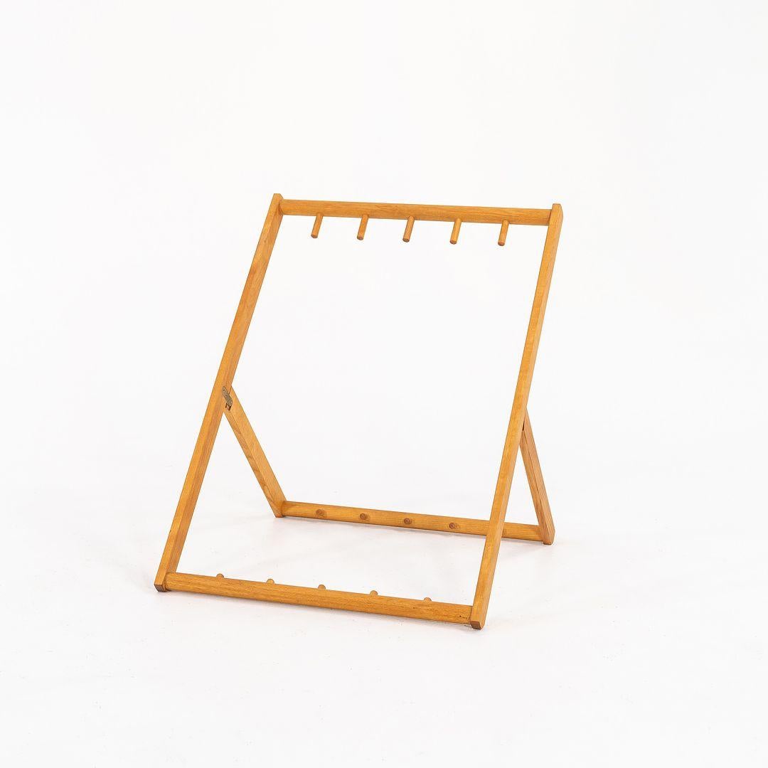 This is a listing for two (2) MK99201 Folding Chair Racks, made for six MK99200 Folding Chairs, made with solid oiled beech wood. The rack, designed by Mogens Koch and produced by Carl Hansen & Son in Denmark, dates to circa 2021 and is guaranteed
