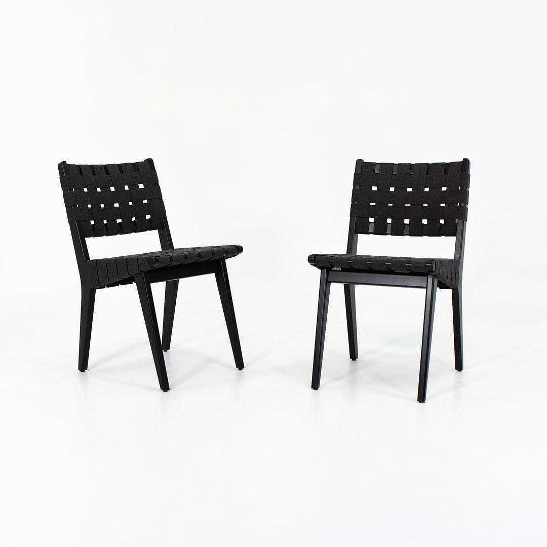 This is a pair of Risom side chairs, Model 666C-WB, designed by Jens Risom for Knoll in 1943. These examples date to 2021. Their design features an ebonized maple frame, and has black cotton webbing on the seat and back. 
 
 Each chair measures 18