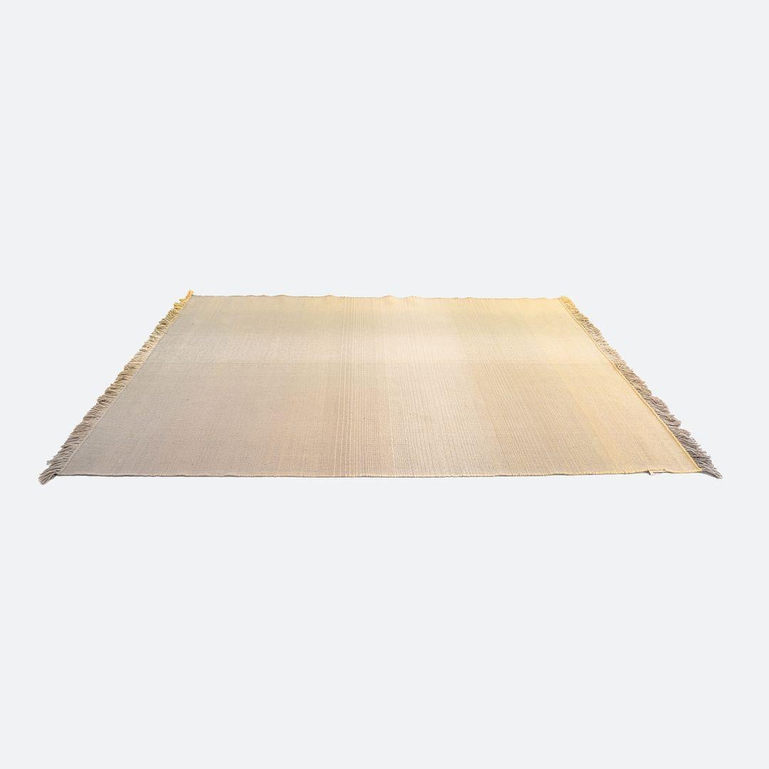 This is a Shade Rug hand loomed with pure New Zealand wool in shades of yellow and grey. The rug was designed by Begum Cana Ozgur and produced by Nanimarquina in India. It dates to circa 2022 and is guaranteed as authentic. Condition is very good to