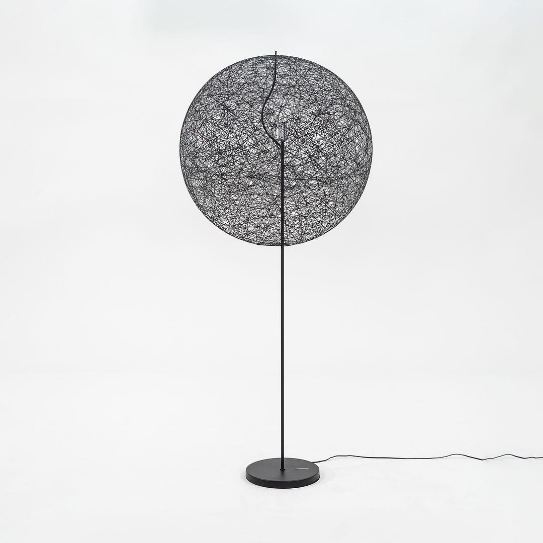 Listed for sale is a Random LED medium floor lamp made of black fiberglass with epoxy resin and a powder coated steel base. The lamp was designed by Bertjan Pot and produced by Moooi¬†in the Netherlands. It dates to circa 2022 and is guaranteed as