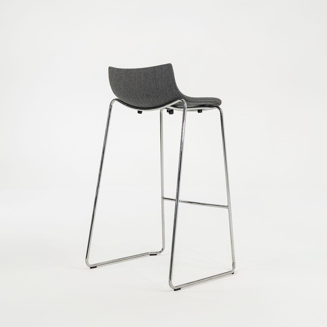 This is a BA004F Preludia Bar Stool, made with a chromed steel frame and a gray Fjord 17 fabric seat. Designed by Brad Ascalon and produced by Carl Hansen & Son in Denmark, the stool dates circa 2022 and is guaranteed as authentic. Condition is