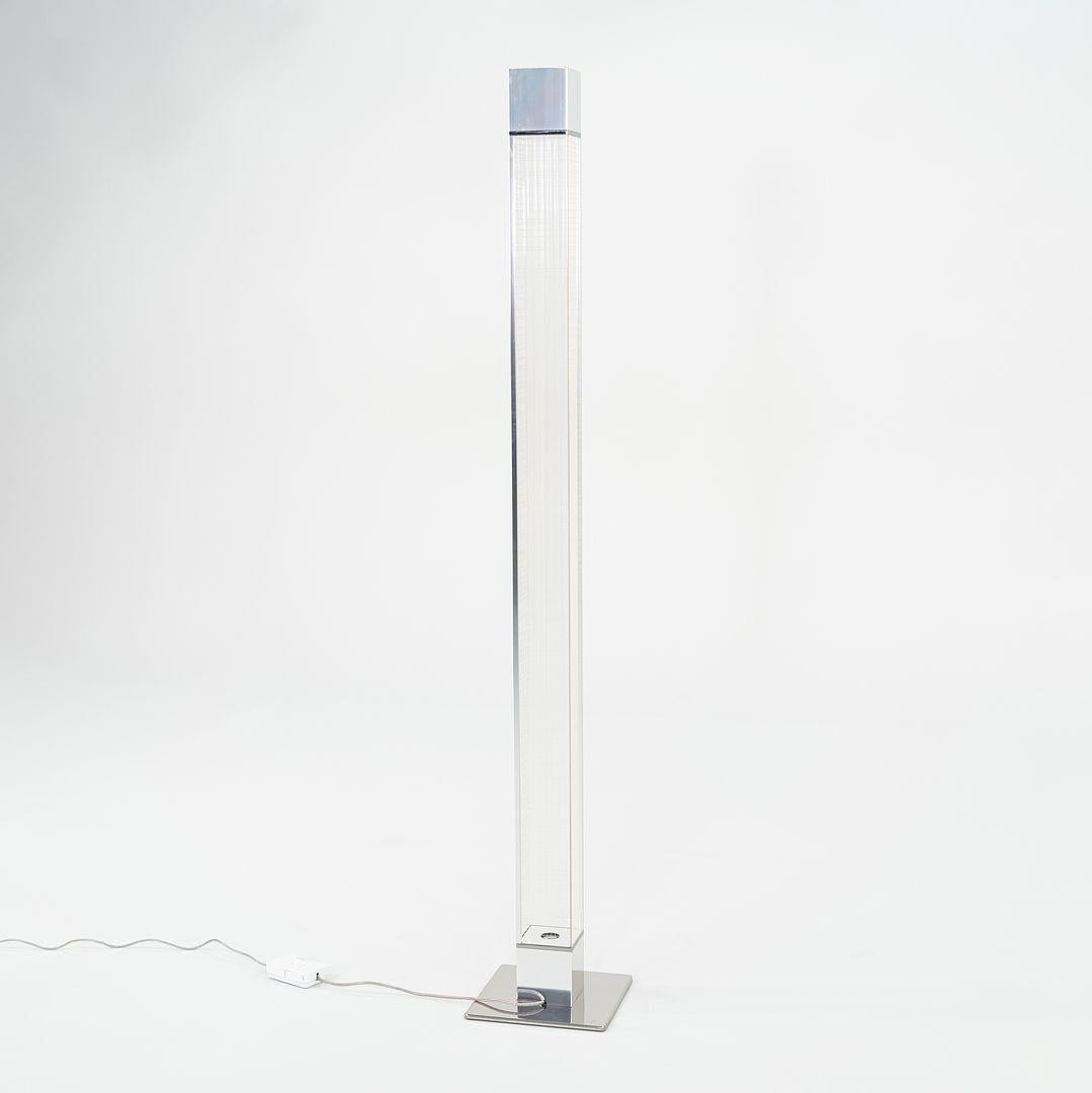 This is a Mimesi LED Floor Lamp made with a polished chrome base and a clear PET polyester column. This lamp was designed by Carlotta de Bevilacqua and produced by Artemide in Italy. It dates to circa 2022 and is guaranteed as authentic. Condition