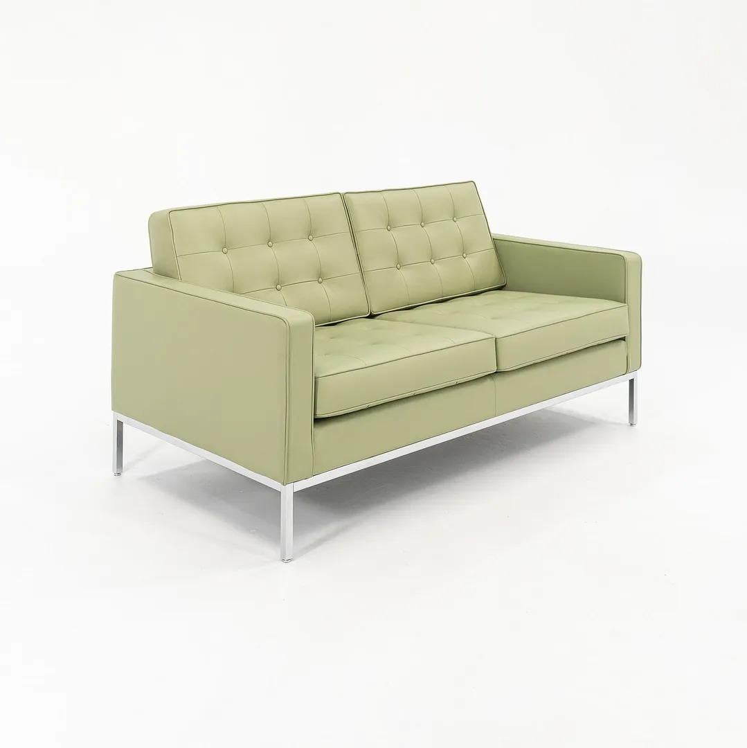 This is a two-seater ‘Florence Knoll’ settee sofa, model 1205S2. The piece was originally designed by Florence Knoll in 1954. This example dates to 2022, and is upholstered in its original light green Spinneybeck leather. The design features a