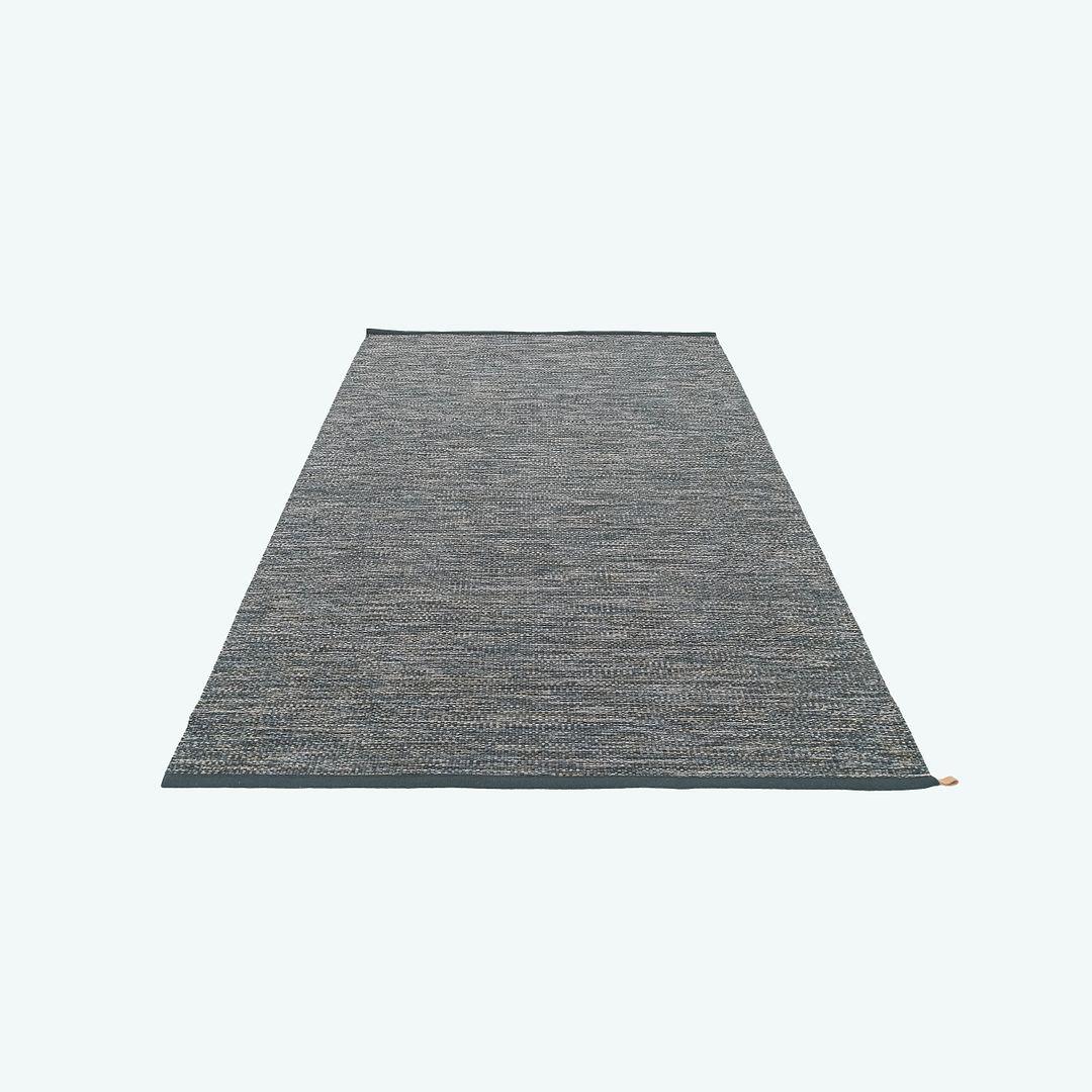 This is a Greta Rug woven in pure wool in shades of blue and grey. The rug was designed by Gunilla Lagerhem Ullberg and produced by Kasthall in Sweden. It dates to circa 2022 and is guaranteed as authentic. Condition is very good to excellent. See