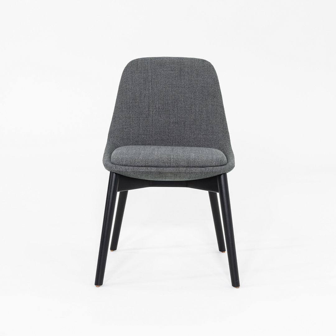 This is a pair of Chloe Dining Side Chairs, originally designed by Noe Duchaufour-Lawrance for Bernhardt Design in 2017. These particular examples were produced in 2022. Each chair features a molded seat and back upholstered in a soft grey fabric