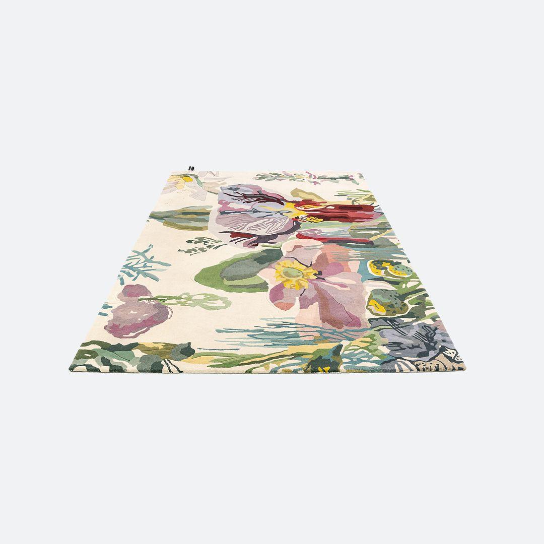 This is a Flora Backyard Rug hand tufted with wool in in a multi-colored floral design. The rug was designed by Santi Moix and produced by Nanimarquina in India. It dates to circa 2022 and is guaranteed as authentic. Condition is good. It does need