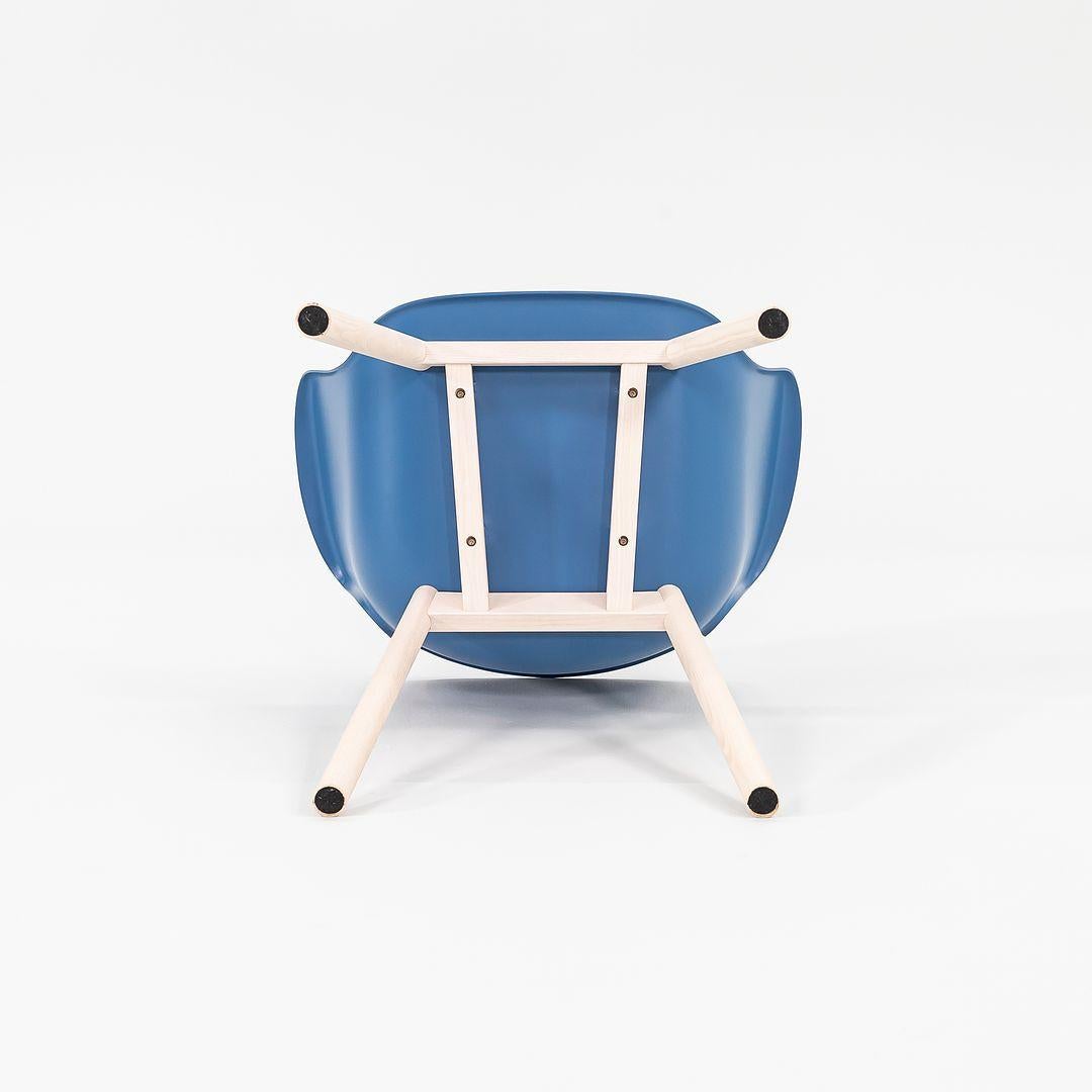 Listed for sale is a Juli Plastic Armchair made of blue polyethylene with bleached ash wood legs. The chair was designed by Werner Aisslinger and produced by Cappellini¬†in Italy. It dates to circa 2022 and is guaranteed as authentic.¬†Condition is