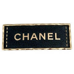 2023 Chanel A23S Gold Tone Black Leather Logo Plate Bar Brooch
