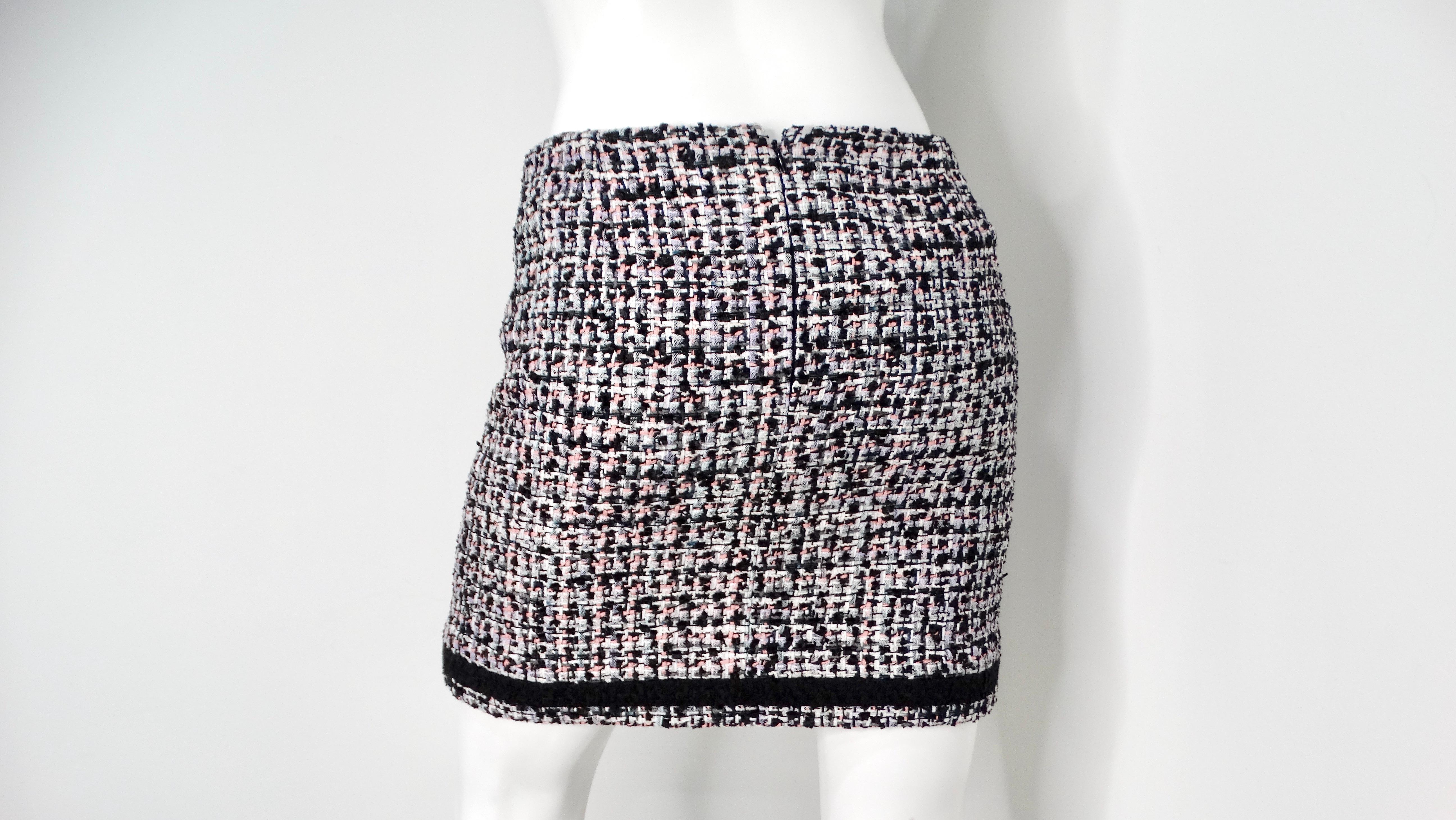 The 2023 Chanel Black, White & Pink Tweed Mini Skirt is a statement piece that embodies classic elegance with a playful twist. This meticulously crafted skirt features a timeless black and white tweed base, subtly infused with delicate hints of pink
