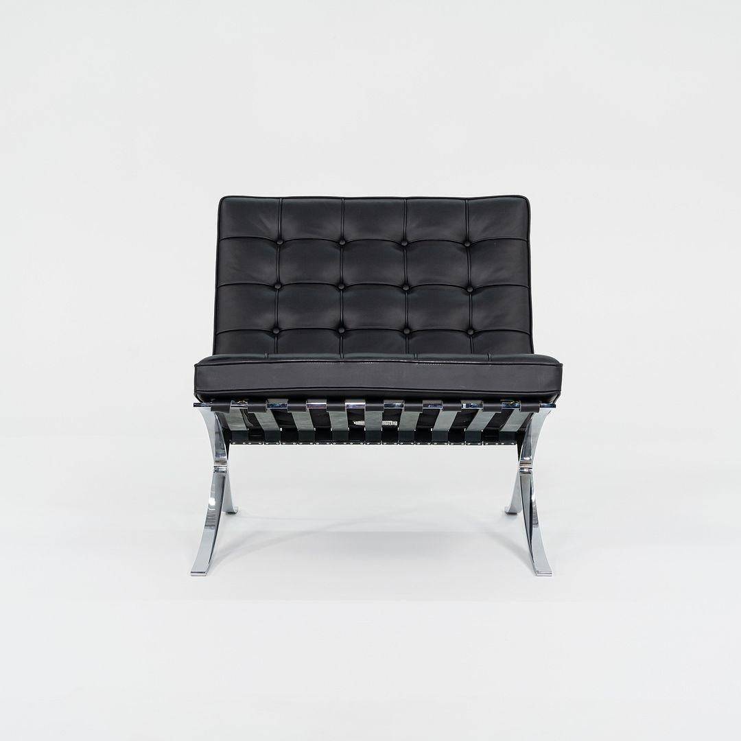 This is an authentic Barcelona Lounge Chair, initially designed by Mies van der Rohe and Lilly Reich in 1929. This example was produced by Knoll in 2023. It features a chromed steel frame and has black leather upholstery.
 
 The chair measures 30