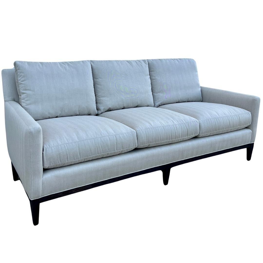Custom made LEE Industries 1399-03 Sofa. This sofa is showroom new and has never been used.

A sofa that is tailored and chic, with refined proportions that allow plenty of room for lounging. Features track arms and a wood base for natural