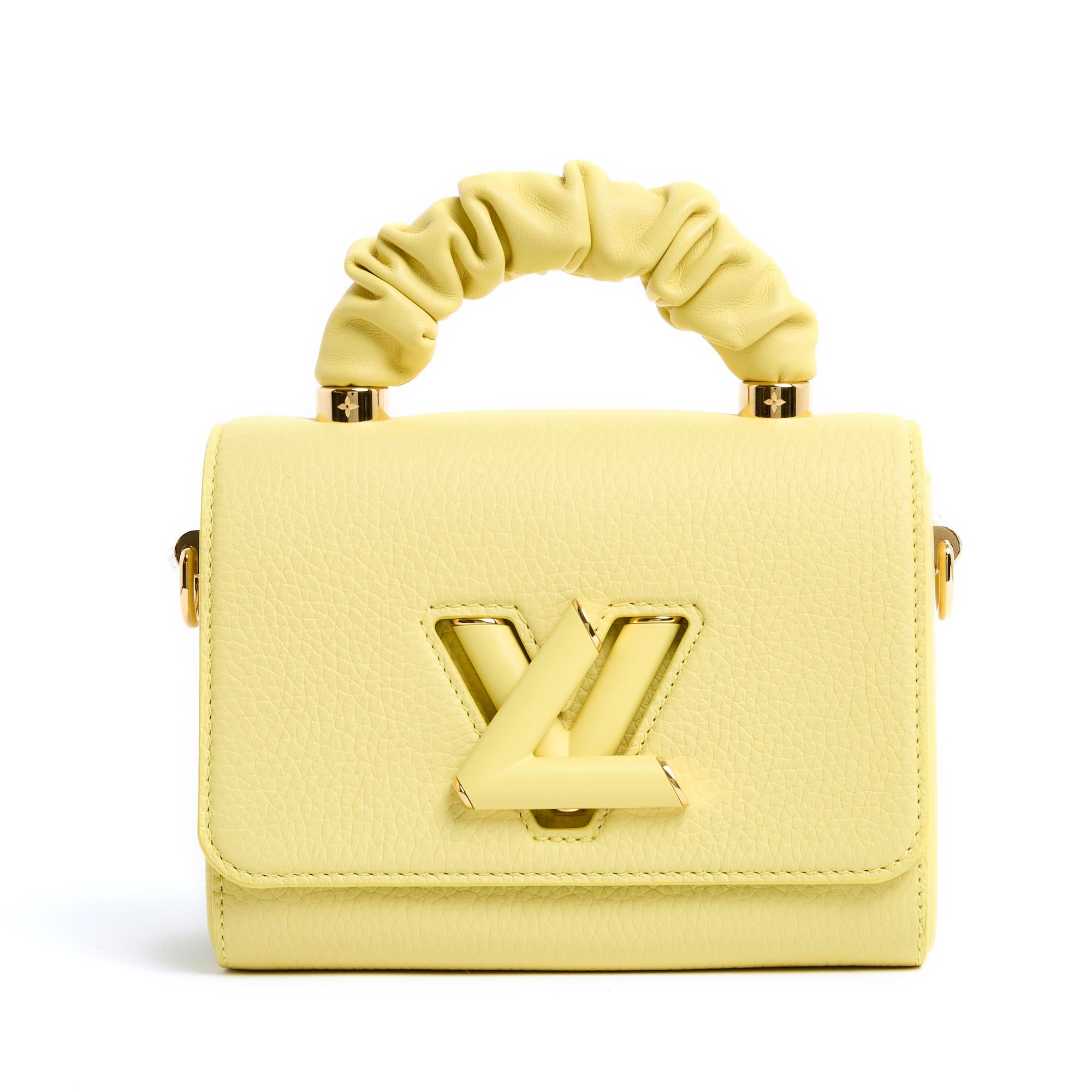 Louis Vuitton Twist Handle model PM size bag in yellow grained leather, interior coordinated with a patch pocket, swivel clasp with the brand logo in gold metal, leather-covered handle for carrying in the hand, adjustable and removable shoulder