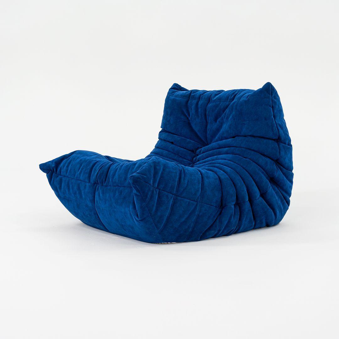 Listed for sale is a TOGO Fireside Chair made of polyether foam covered in Infanta Blue alcantara fabric. The chair was designed by Michel Ducaroy and produced by Ligne Roset¬†in France. It was made circa 2023 and is guaranteed as