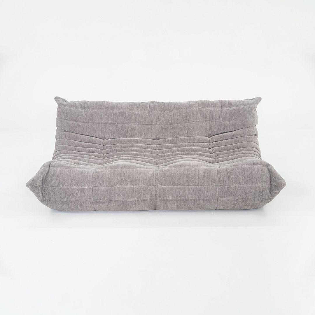 This is a Three Seat Togo Sofa, originally designed by Michel Ducaroy in 1973. This particular example was produced by Ligne Roset in France in 2023. The sofa is made of polyether foam covered in Lhuis Gris fabric. 
 

 The sofa measures 41.25