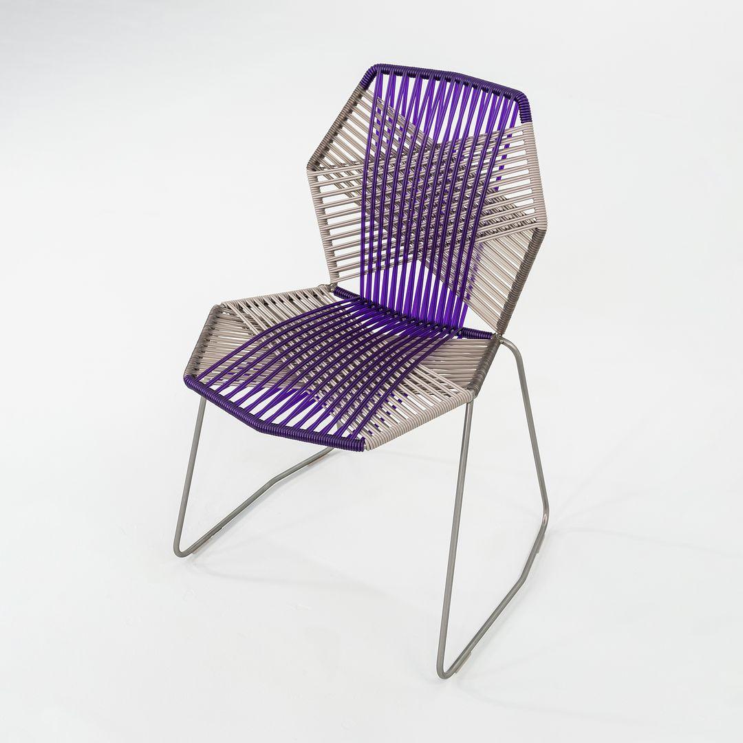 This is a Tropicalia side chair, originally designed by Patricia Urquiola in 2008. This particular example was produced by Moroso in Italy circa 2023. The chair is comprised of a tubular stainless steel base with a powder coated finish and polymer