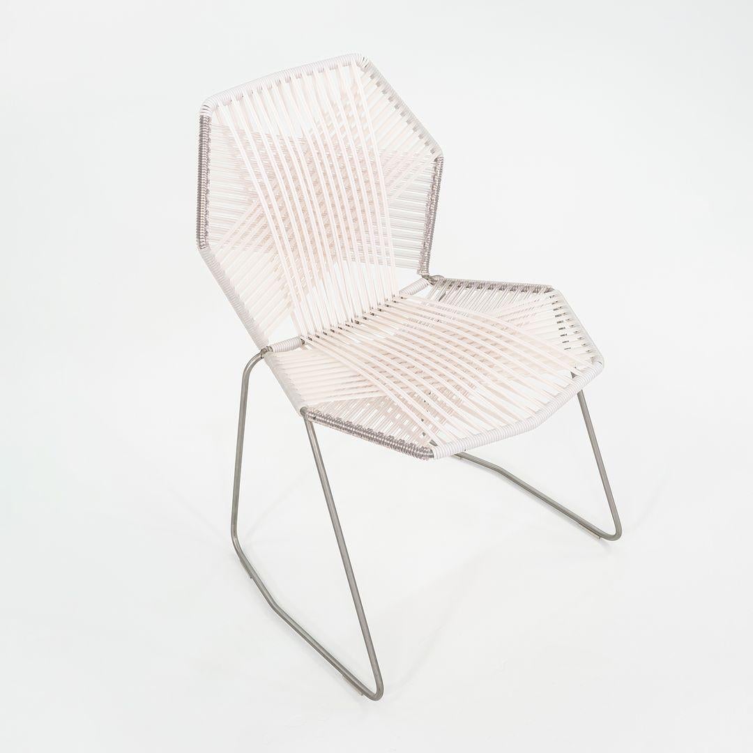 This is a Tropicalia side chair, originally designed by Patricia Urquiola in 2008. This particular example was produced by Moroso in Italy circa 2023. The chair is comprised of a tubular steel base with a powder coated finish and polymer cord woven