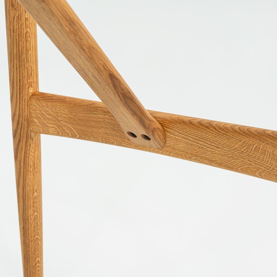 This is a Preludia bar table BA102-15060, originally designed by Brad Ascalon in 2018. This particular example was produced by Carl Hansen in Denmark in 2023 The table is comprised of an oak base with a laminate tabletop. 
 
 This Preludia bar table