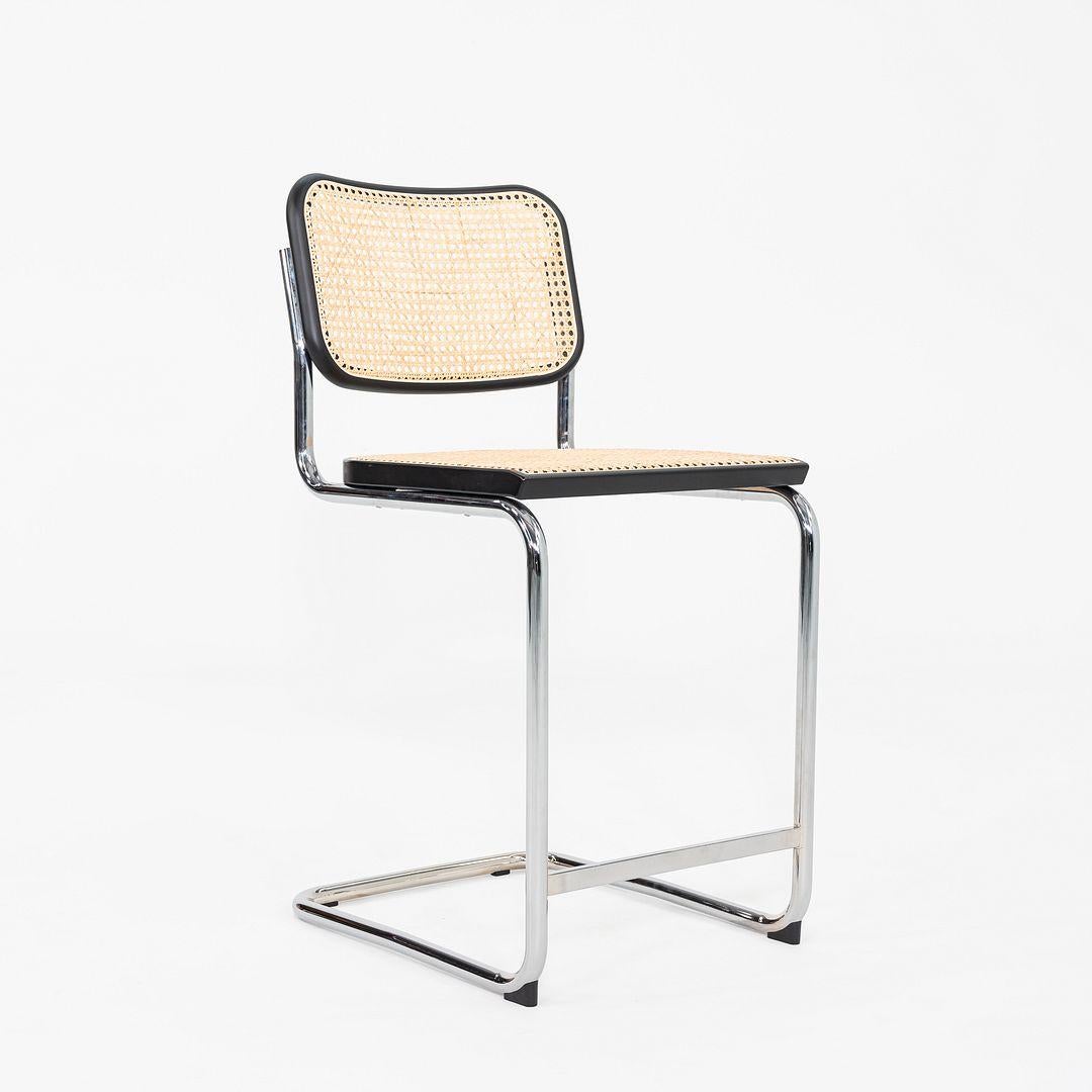 This is a set of three Cesca Counter Stools, originally designed by Marcel Breuer in 1928. These particular examples were produced by Knoll in the USA C. 2023. Their design features a chrome plated tubular steel frame and a seat comprised of black