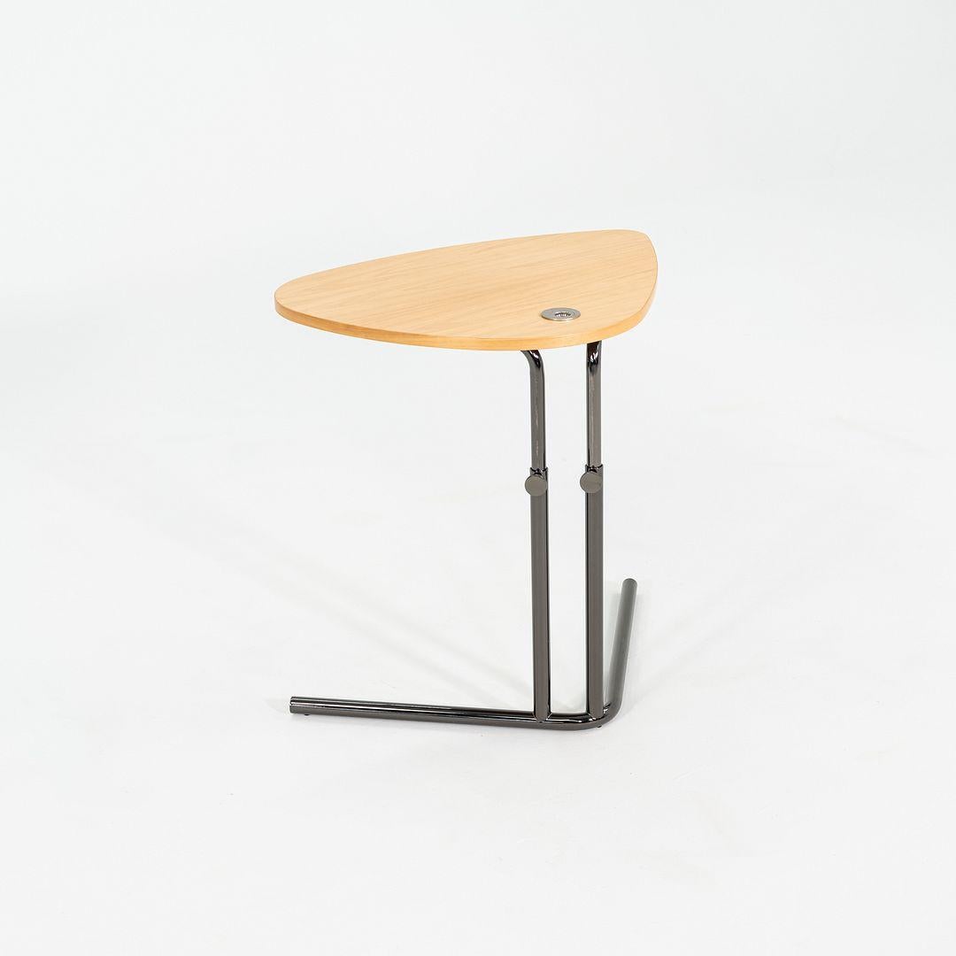 This is a K22 asymmetrical mobile table, designed and produced by Tecta. This particular example was made in Germany C. 2023. The table is comprised of a tubular steel frame, which is height adjustable, and an oak tabletop.
 
 The table measures 24